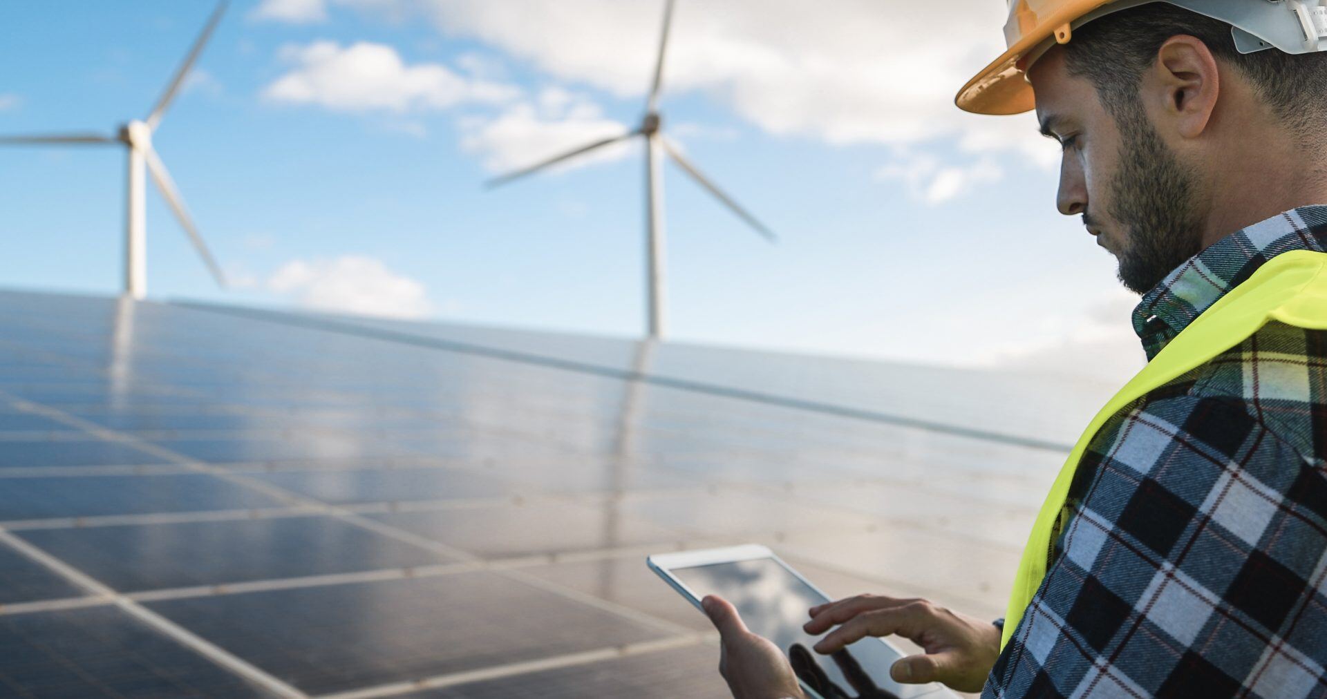 young-man-working-with-digital-tablet-at-renewable-FY7899J