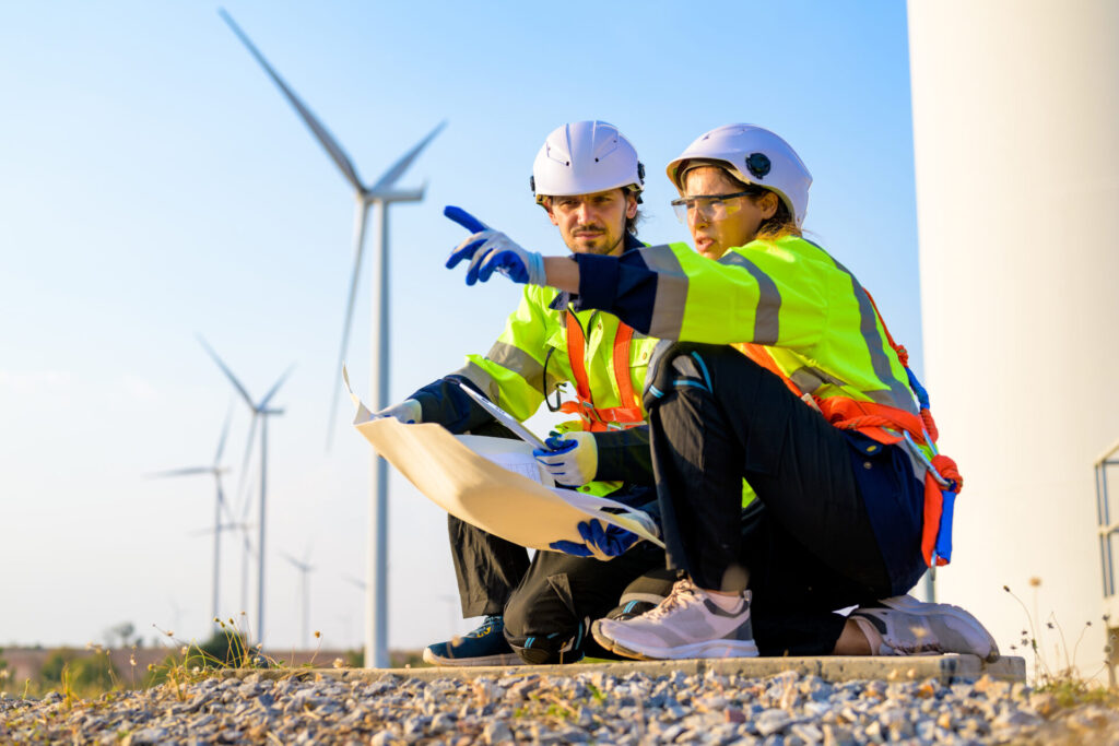 Technicians working outdoor at wind power plant.